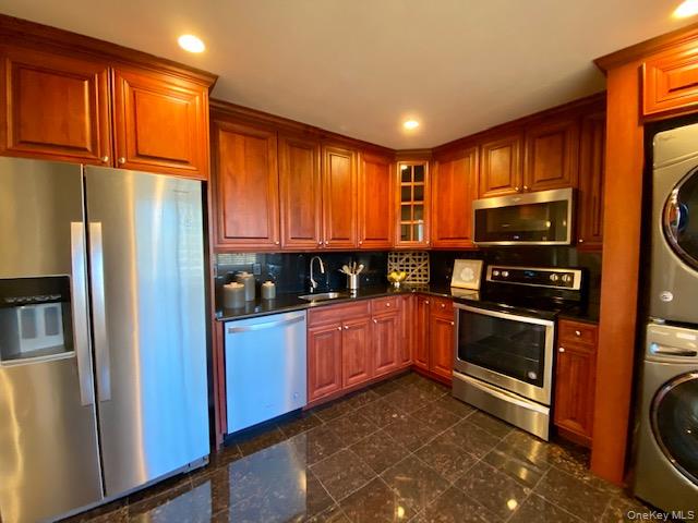 1314 Smithtown Avenue, Unit 34 Bohemia, NY 11716 - Photo 3 of 3 a kitchen with stainless steel appliances granite countertop a refrigerator a stove and a sink