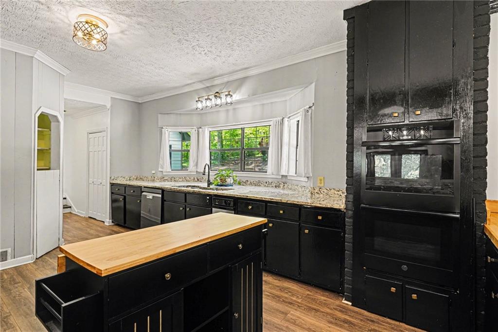 2133 Cooper Way Jonesboro, GA 30236 - Photo 12 of 46 a kitchen with stainless steel appliances a sink stove and cabinets