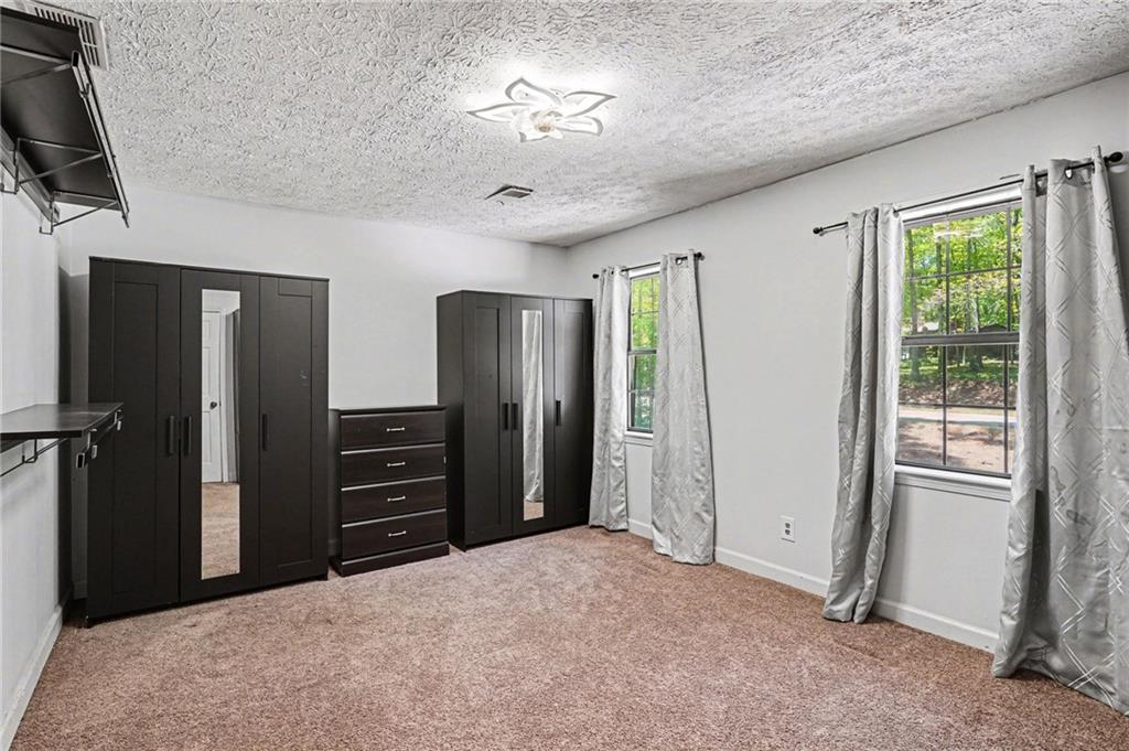 2133 Cooper Way Jonesboro, GA 30236 - Photo 27 of 46 a view of a bedroom with closet ceiling fan and windows