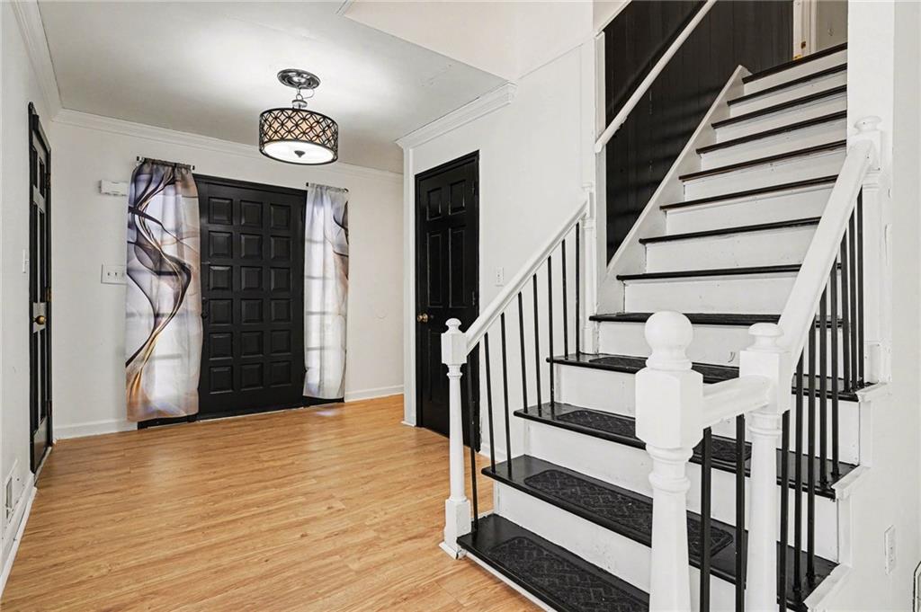 2133 Cooper Way Jonesboro, GA 30236 - Photo 4 of 46 a view of a hallway with wooden floor and staircase