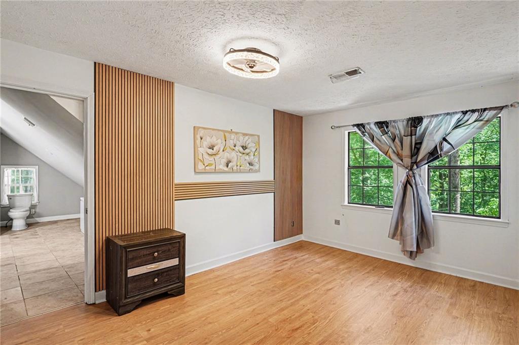 2133 Cooper Way Jonesboro, GA 30236 - Photo 8 of 46 a view of an empty room with a window and hardwood floor