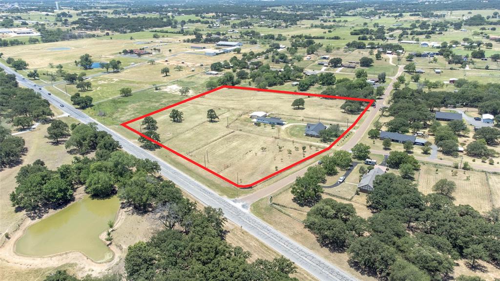 151 County Road 3699 Springtown, TX 76082 - Photo 35 of 35 Expansive land parcel with direct road frontage, featuring mature trees and a residential structure