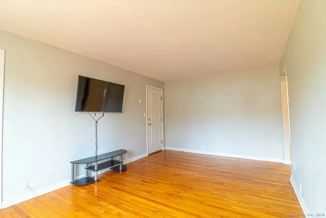a picture of a bench in front of a white house
