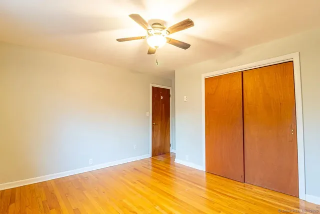 a view of a room with a window and ceiling fan
