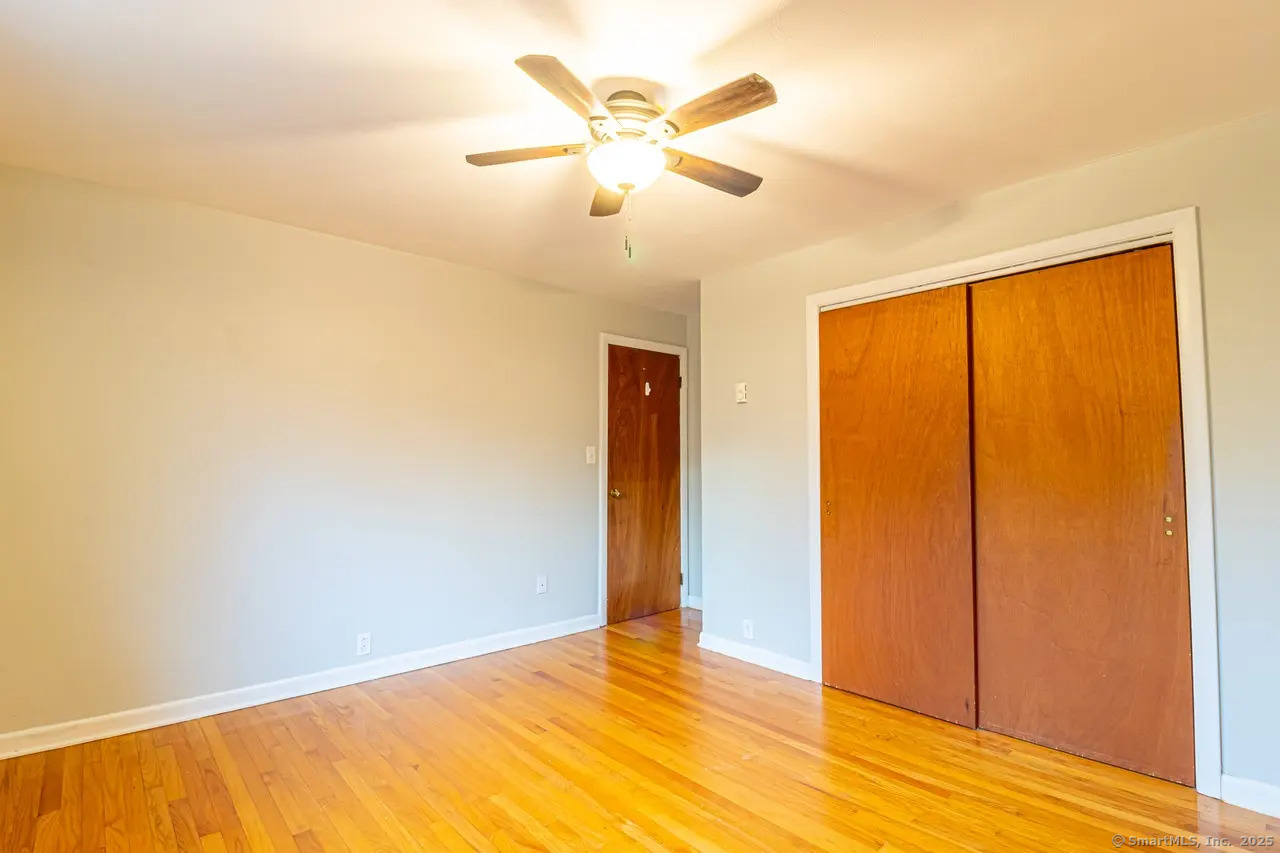 405 Noank Ledyard Road Groton, CT 06355 - Photo 4 of 17 a view of an empty room with wooden floor