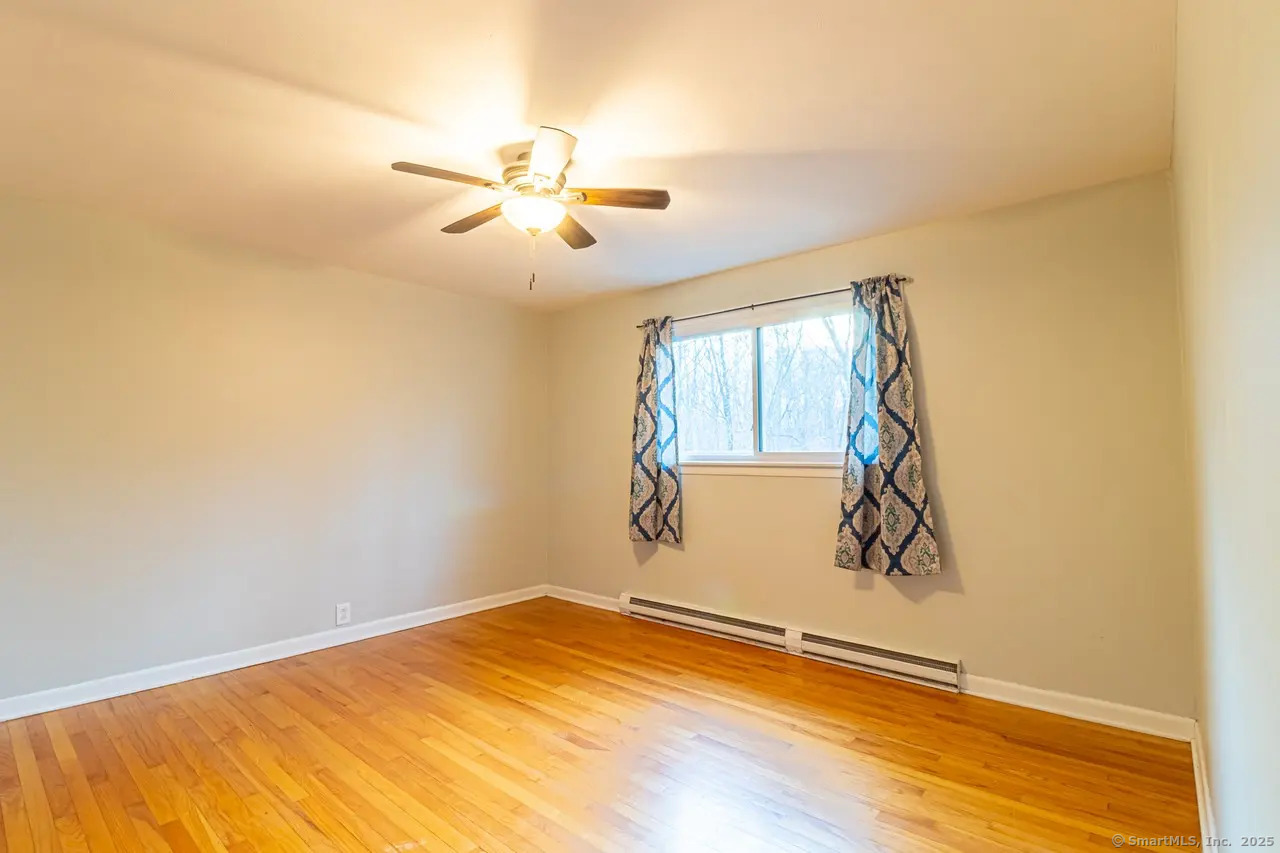 405 Noank Ledyard Road Groton, CT 06355 - Photo 5 of 17 a view of a room with a window and ceiling fan