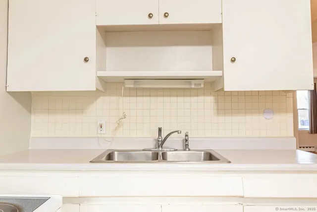 a bathroom with a sink a vanity and a shower