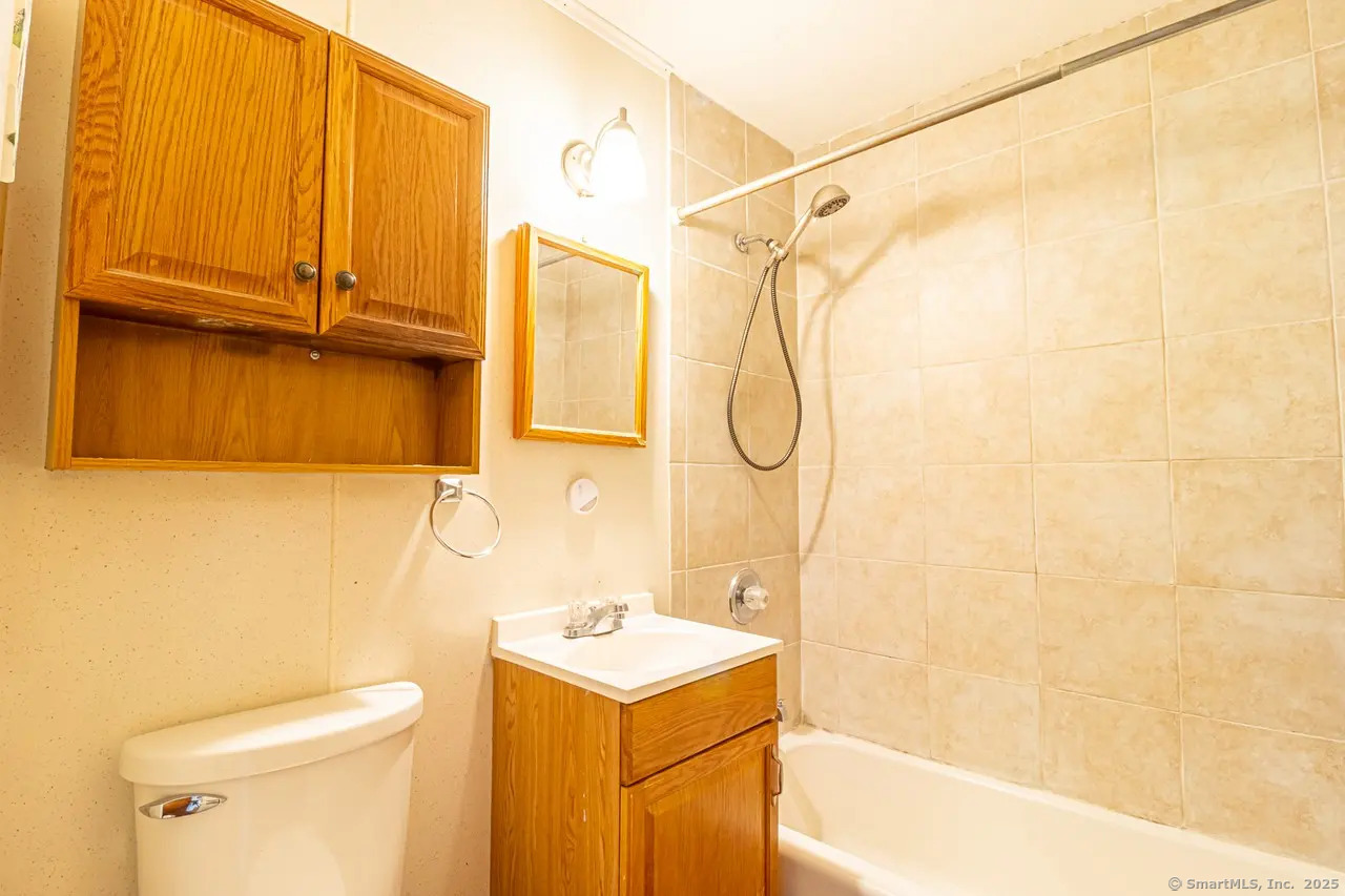 405 Noank Ledyard Road Groton, CT 06355 - Photo 10 of 17 a bathroom with a sink a vanity and a shower