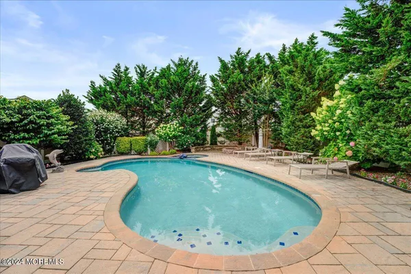 a view of a swimming pool with an outdoor seating