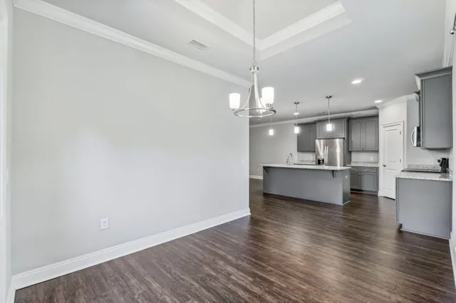 a view of kitchen with refrigerator and window