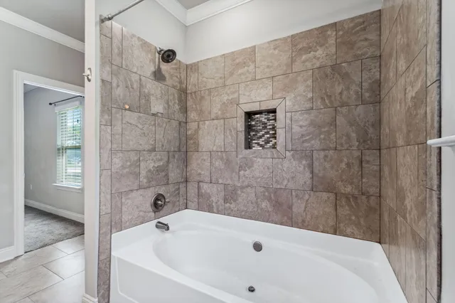 a bathroom with a white bath tub and a shower