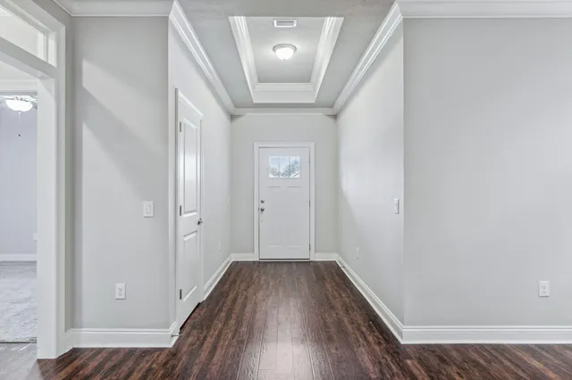a view of a hallway with wooden floor
