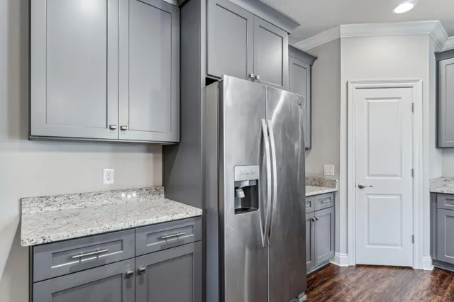 a kitchen with a refrigerator and cabinets