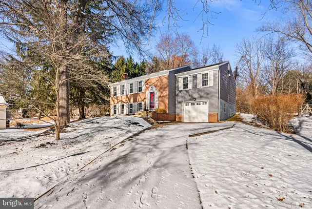 a view of a house with snow on the road