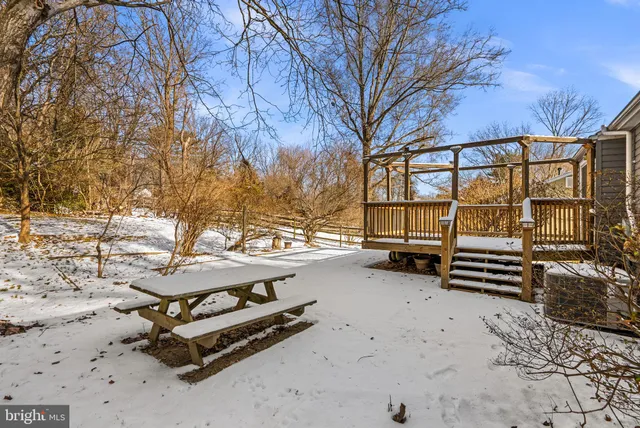 a view of a bench in backyard of a house