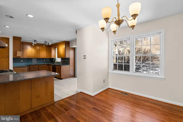 a view of a livingroom with a chandelier furniture and a large window
