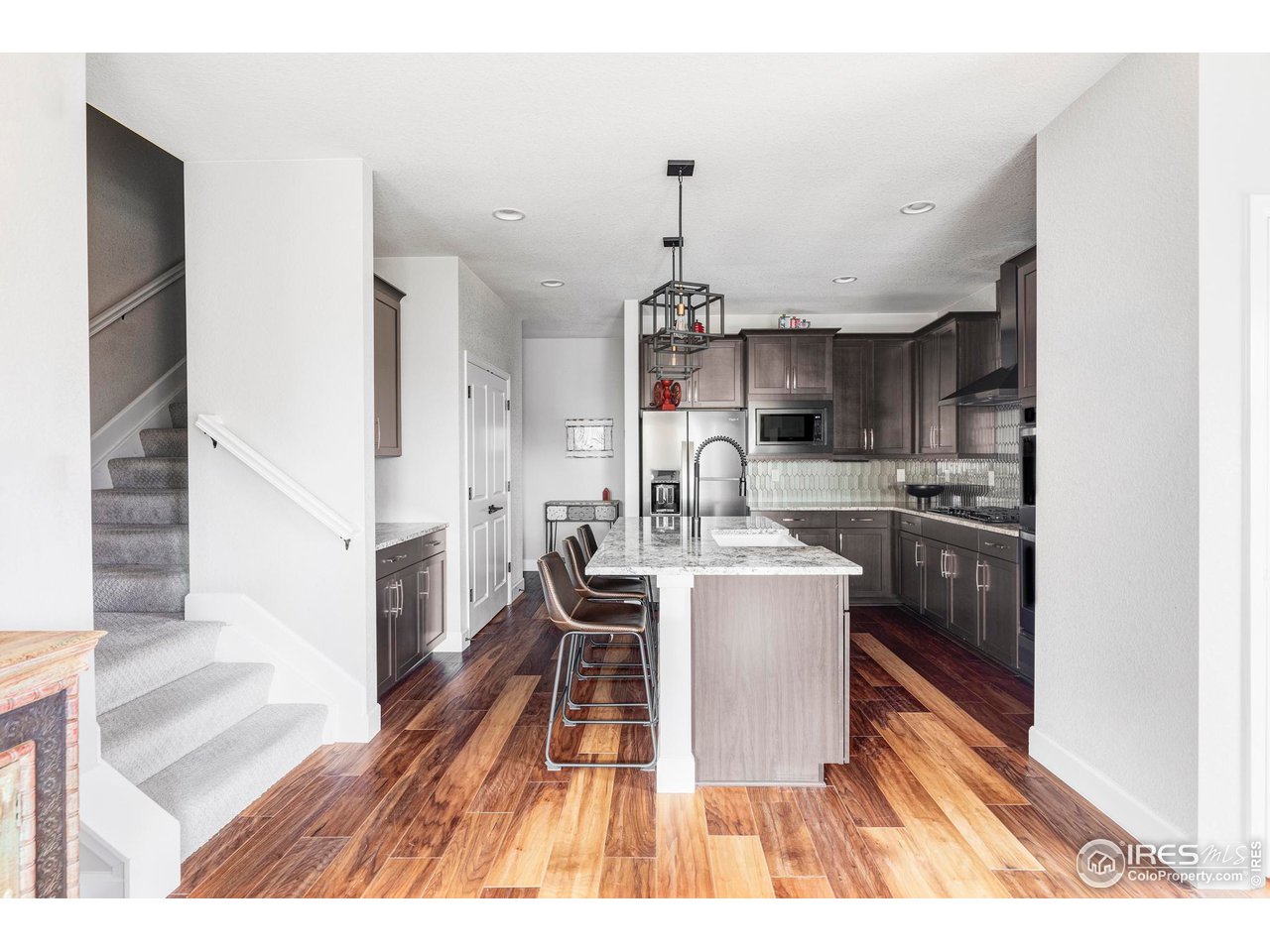 784 Stonebridge Drive Longmont, CO 80503 - Photo 9 of 35 a kitchen with a sink a counter top space and stainless steel appliances