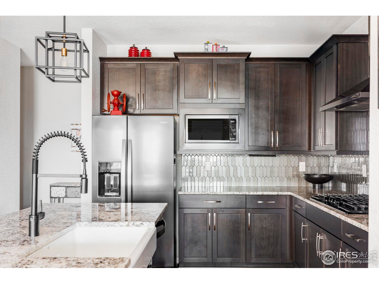 784 Stonebridge Drive Longmont, CO 80503 - Photo 11 of 35 a kitchen with kitchen island a stove and a sink