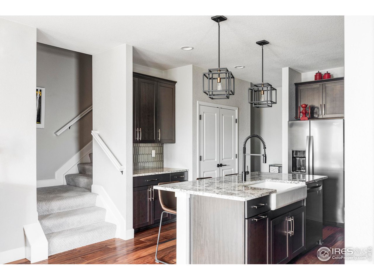784 Stonebridge Drive Longmont, CO 80503 - Photo 13 of 35 a kitchen with stainless steel appliances kitchen island granite countertop a sink and a refrigerator