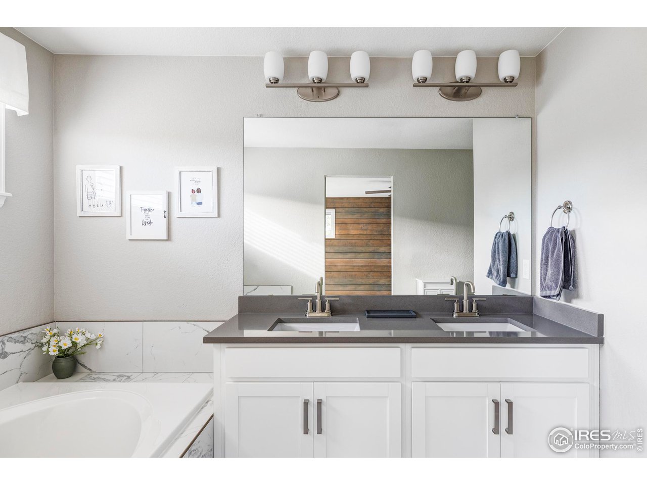 784 Stonebridge Drive Longmont, CO 80503 - Photo 18 of 35 a bathroom with a sink and a mirror