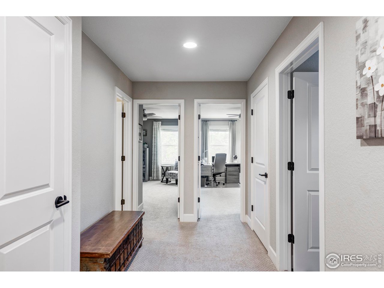 784 Stonebridge Drive Longmont, CO 80503 - Photo 21 of 35 a open hall with wooden floor and a glass door