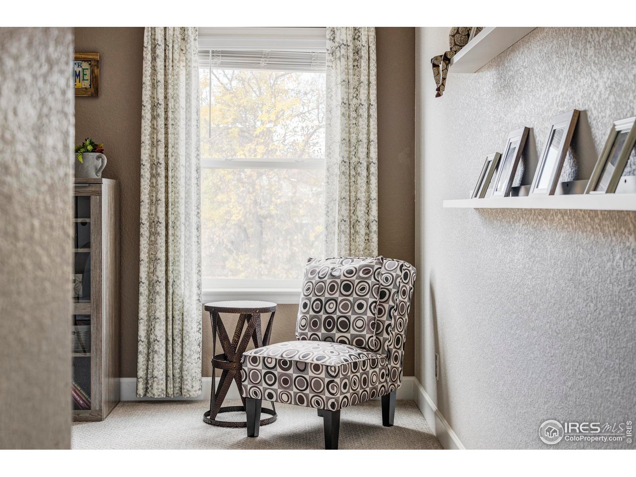 784 Stonebridge Drive Longmont, CO 80503 - Photo 23 of 35 a living room with furniture and a large window