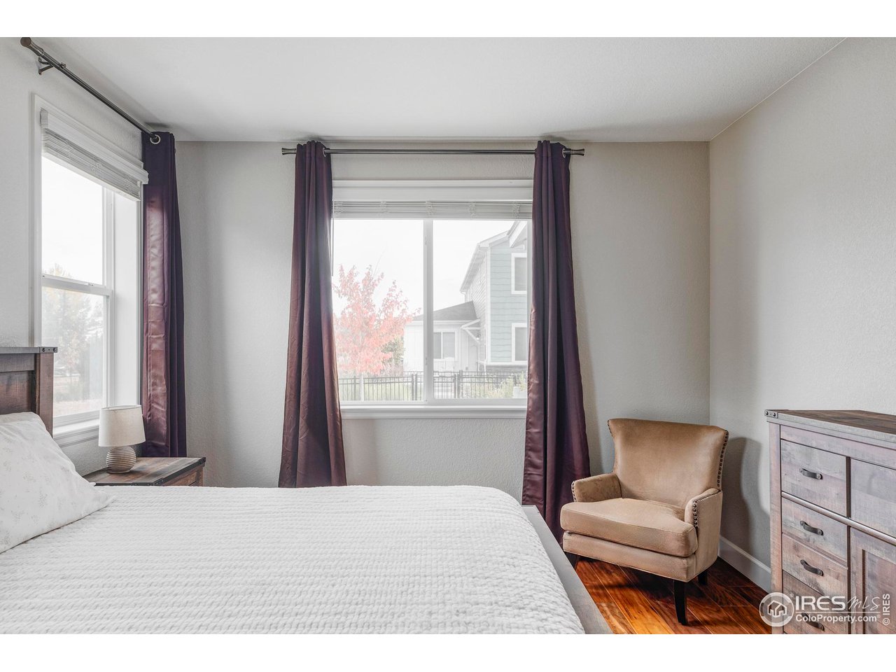 784 Stonebridge Drive Longmont, CO 80503 - Photo 28 of 35 a bedroom with a bed and a chair