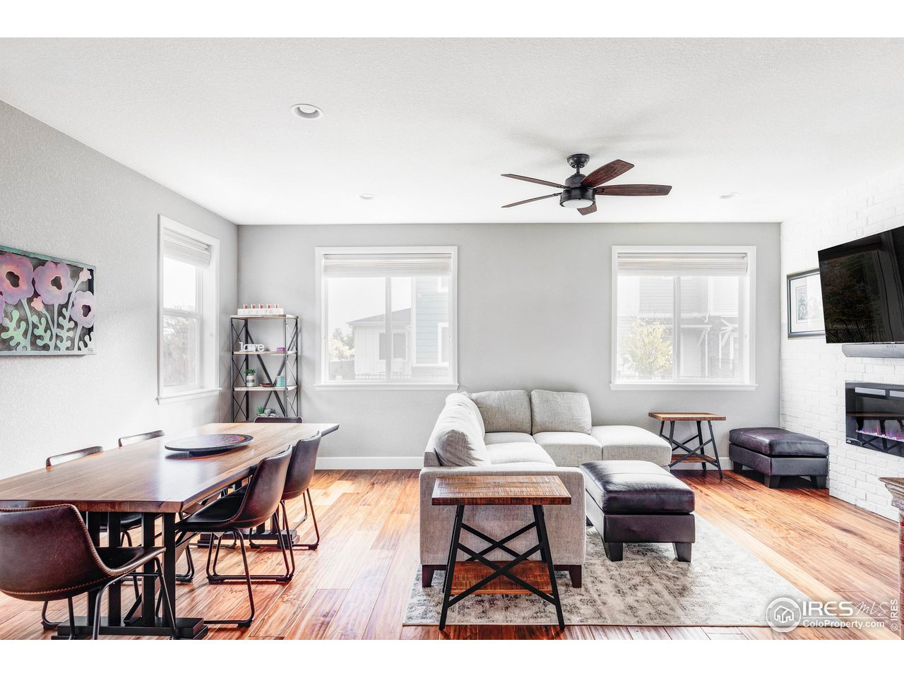 784 Stonebridge Drive Longmont, CO 80503 - Photo 5 of 35 a living room with furniture a flat screen tv and a window