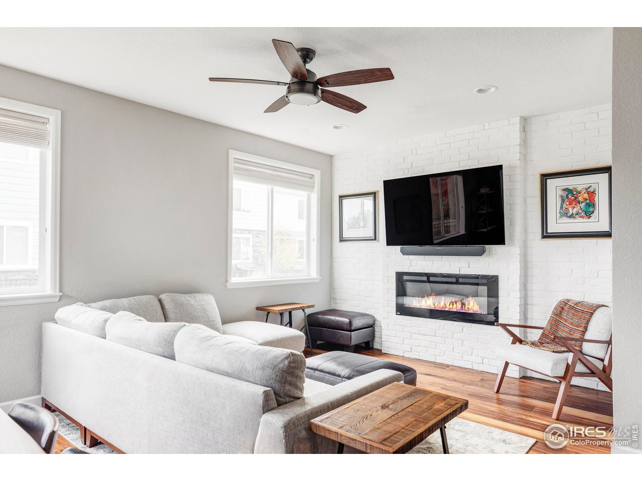 784 Stonebridge Drive Longmont, CO 80503 - Photo 7 of 35 a living room with furniture a flat screen tv and a window