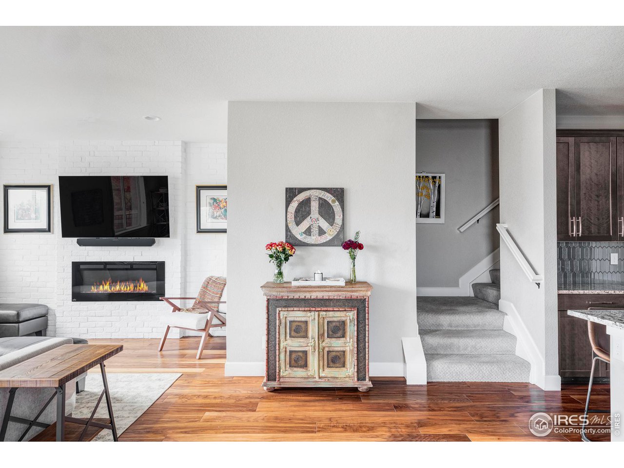 784 Stonebridge Drive Longmont, CO 80503 - Photo 34 of 35 a living room with furniture a flat screen tv and a fireplace