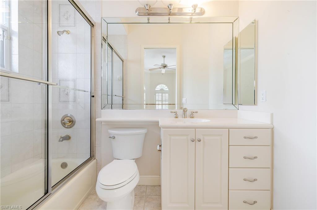 20481 Chapel Trace Estero, FL 33928 - Photo 16 of 50 a bathroom with a toilet a sink a mirror and a shower