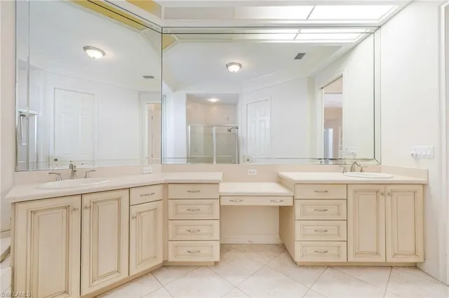 a bathroom with double sink and a mirror