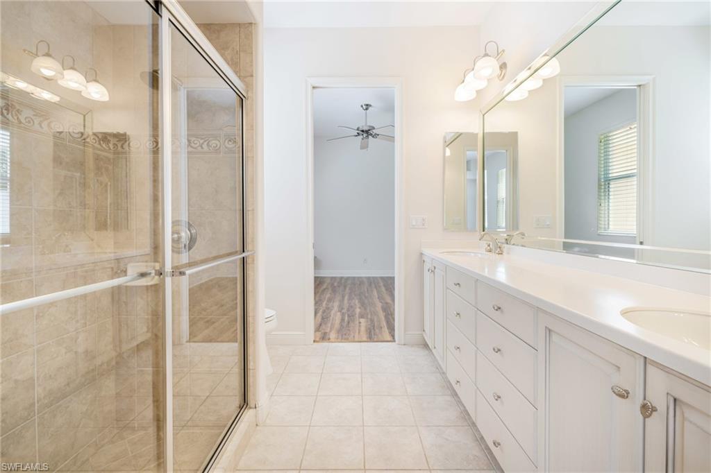 20481 Chapel Trace Estero, FL 33928 - Photo 23 of 50 a bathroom with a double vanity sink and mirror with shower