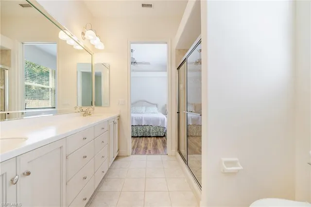 a bathroom with a double vanity sink and mirror