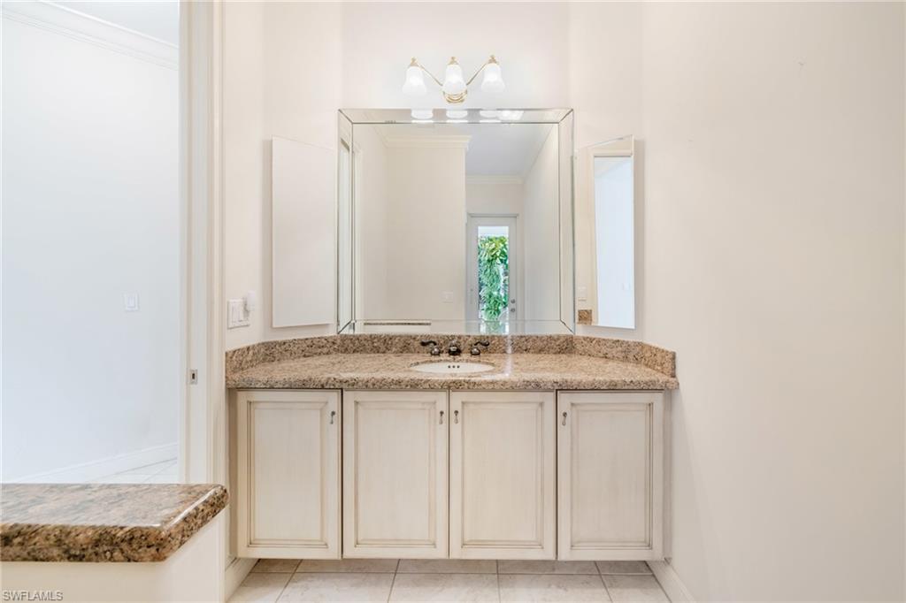 20481 Chapel Trace Estero, FL 33928 - Photo 28 of 50 a bathroom with a granite countertop sink and a mirror