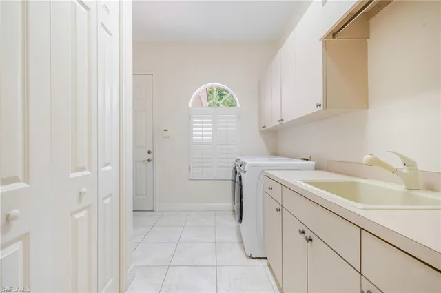a kitchen with a sink cabinets and a window