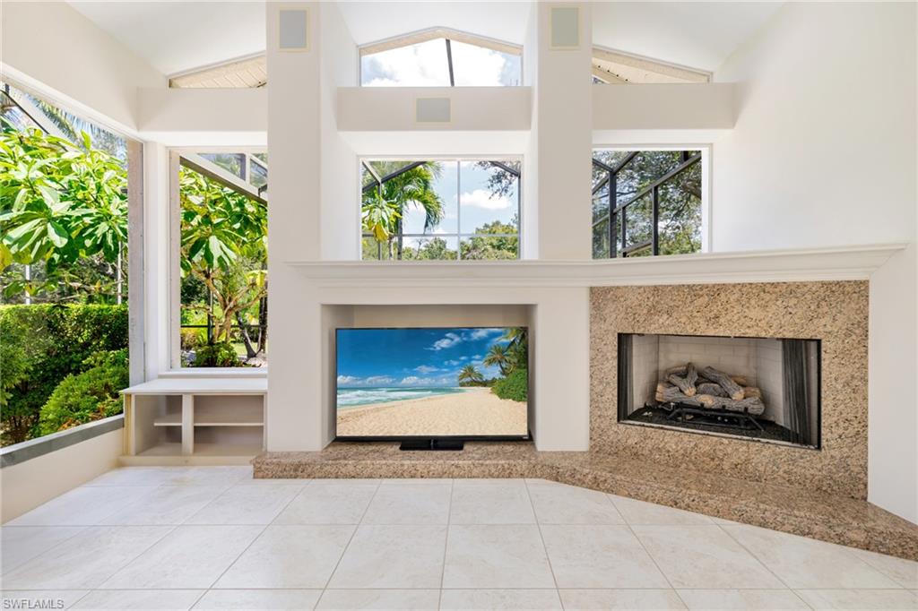 20481 Chapel Trace Estero, FL 33928 - Photo 3 of 50 a living room with a fireplace windows and a potted plant