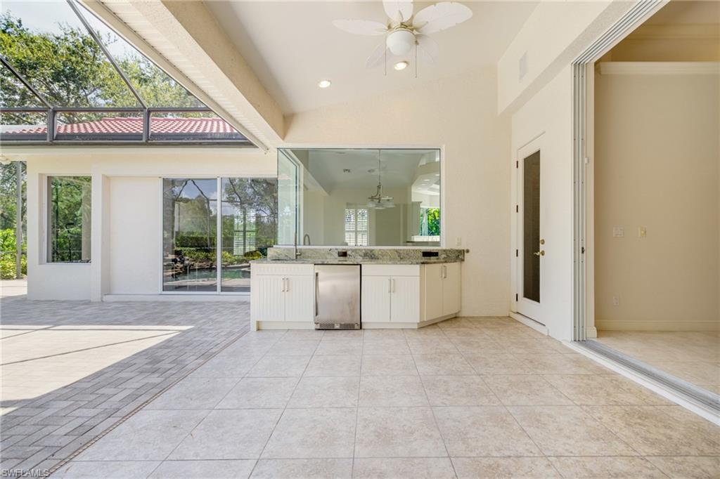 20481 Chapel Trace Estero, FL 33928 - Photo 33 of 50 a view of a kitchen with kitchen island a sink hardwood floor and a large window