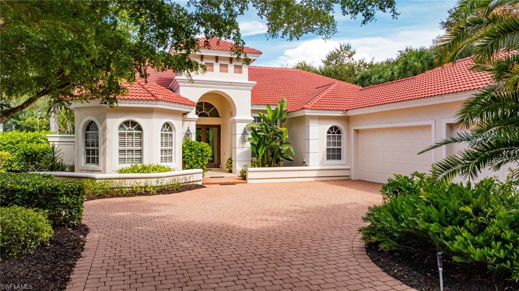 20481 Chapel Trace Estero, FL 33928 - Photo 38 of 50 a front view of a house with a garden