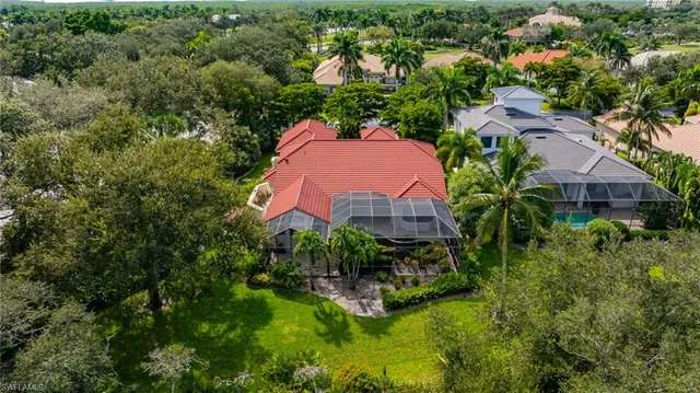 an aerial view of a house with a garden and swimming pool