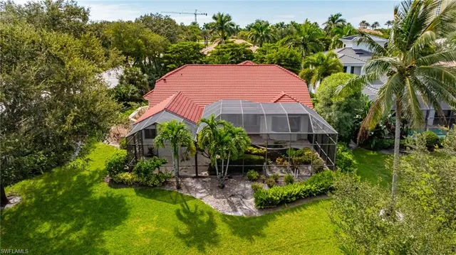 an aerial view of a house with swimming pool and garden