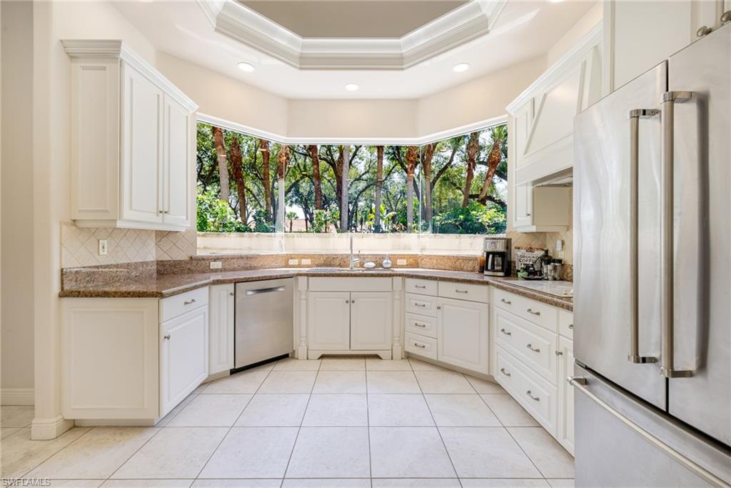 20481 Chapel Trace Estero, FL 33928 - Photo 6 of 50 a kitchen with a sink window and cabinets