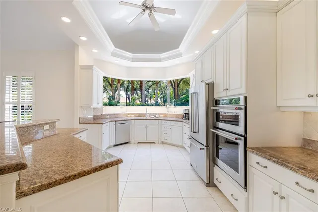 a kitchen with stainless steel appliances granite countertop a sink and a stove