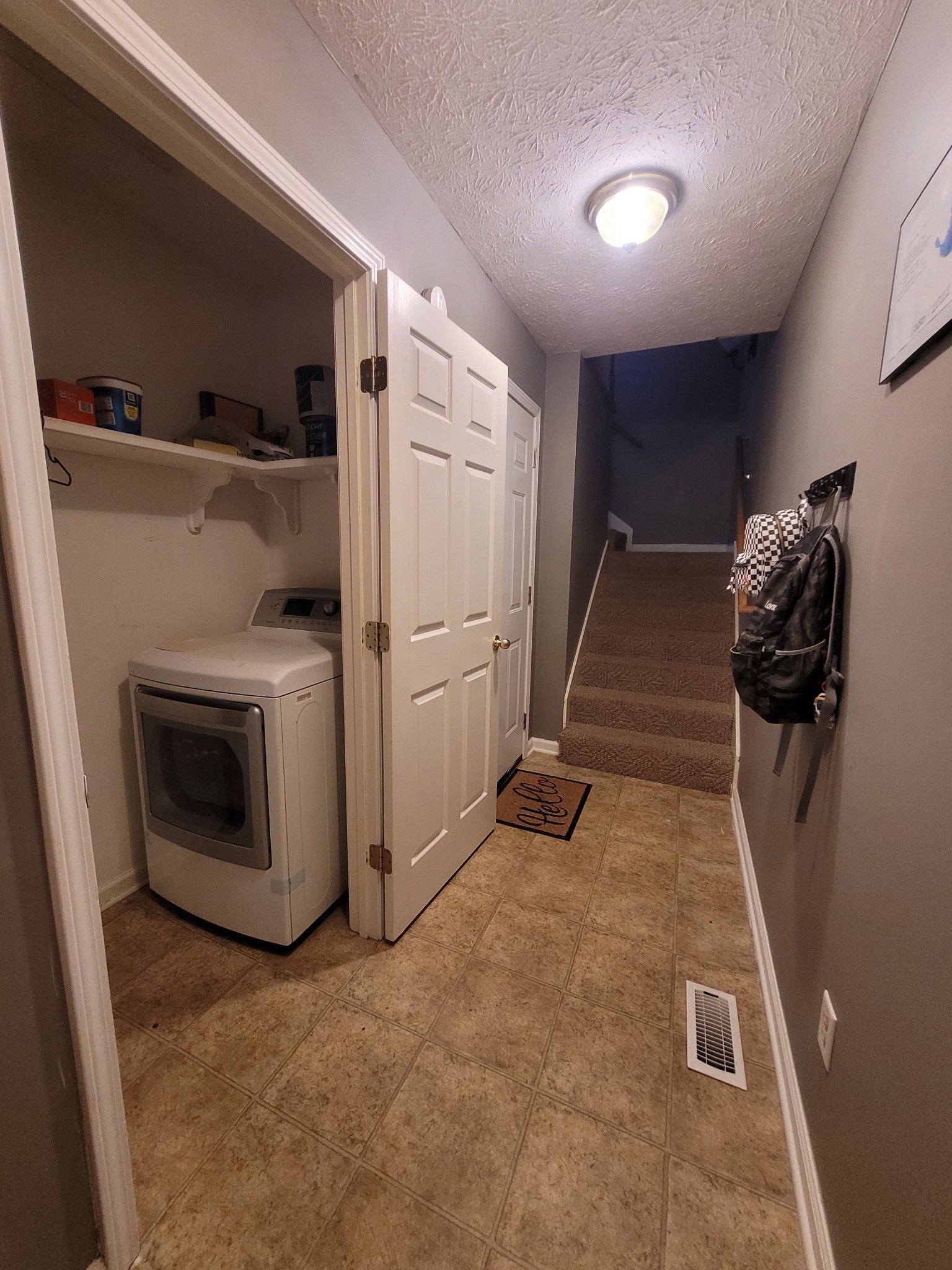 Laundry area between garage entrance and kitchen