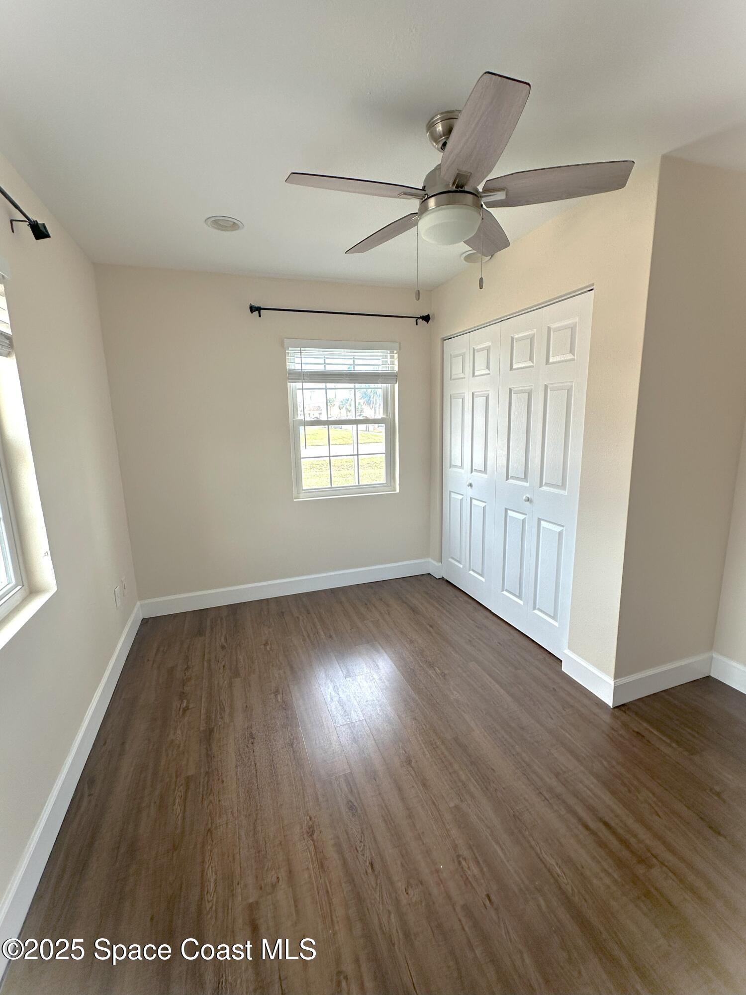202 4th Avenue Indialantic, FL 32903 - Photo 2 of 6 a view of an empty room with wooden floor and a window