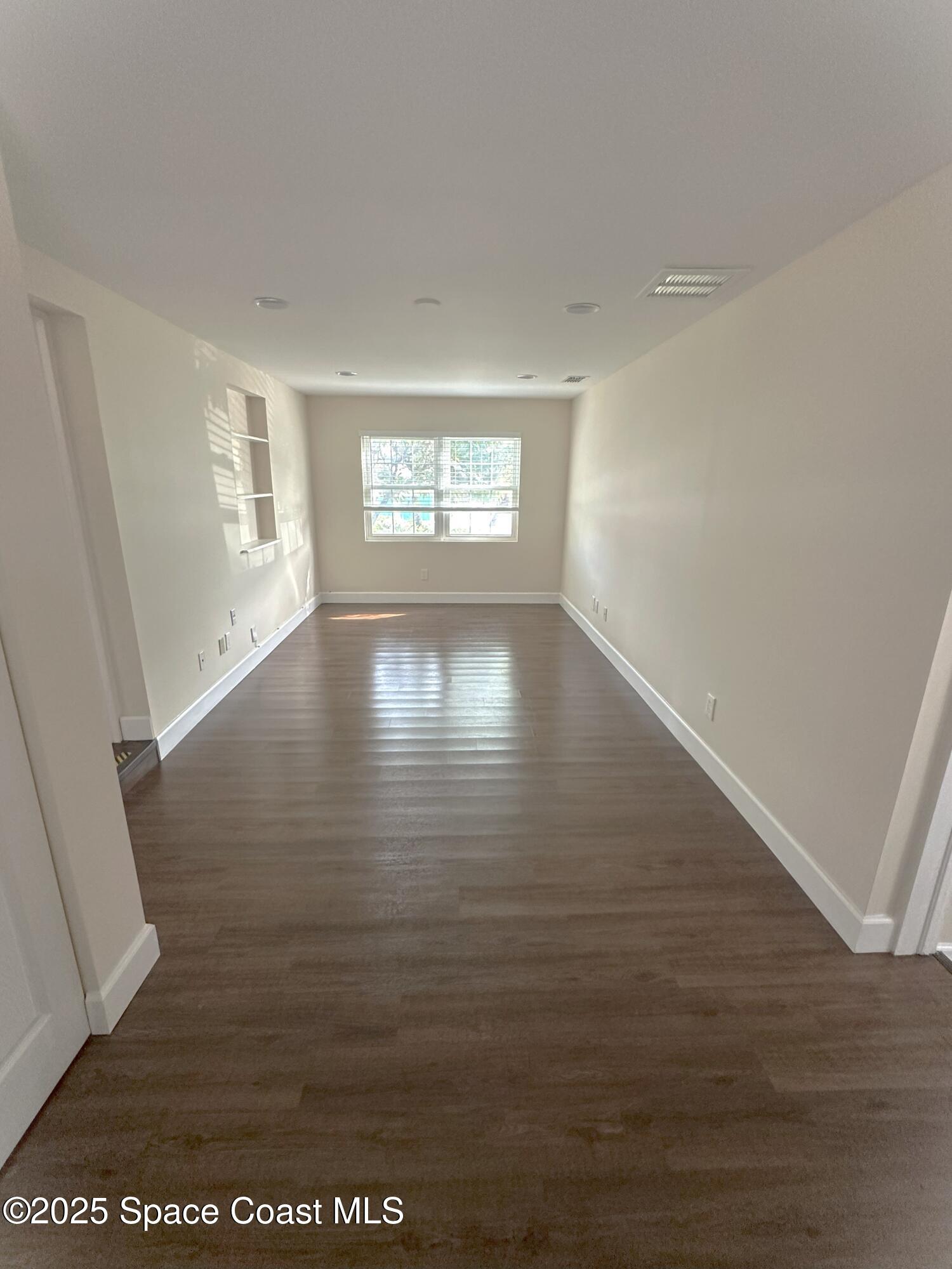 202 4th Avenue Indialantic, FL 32903 - Photo 5 of 6 a view of an empty room with wooden floor and a window
