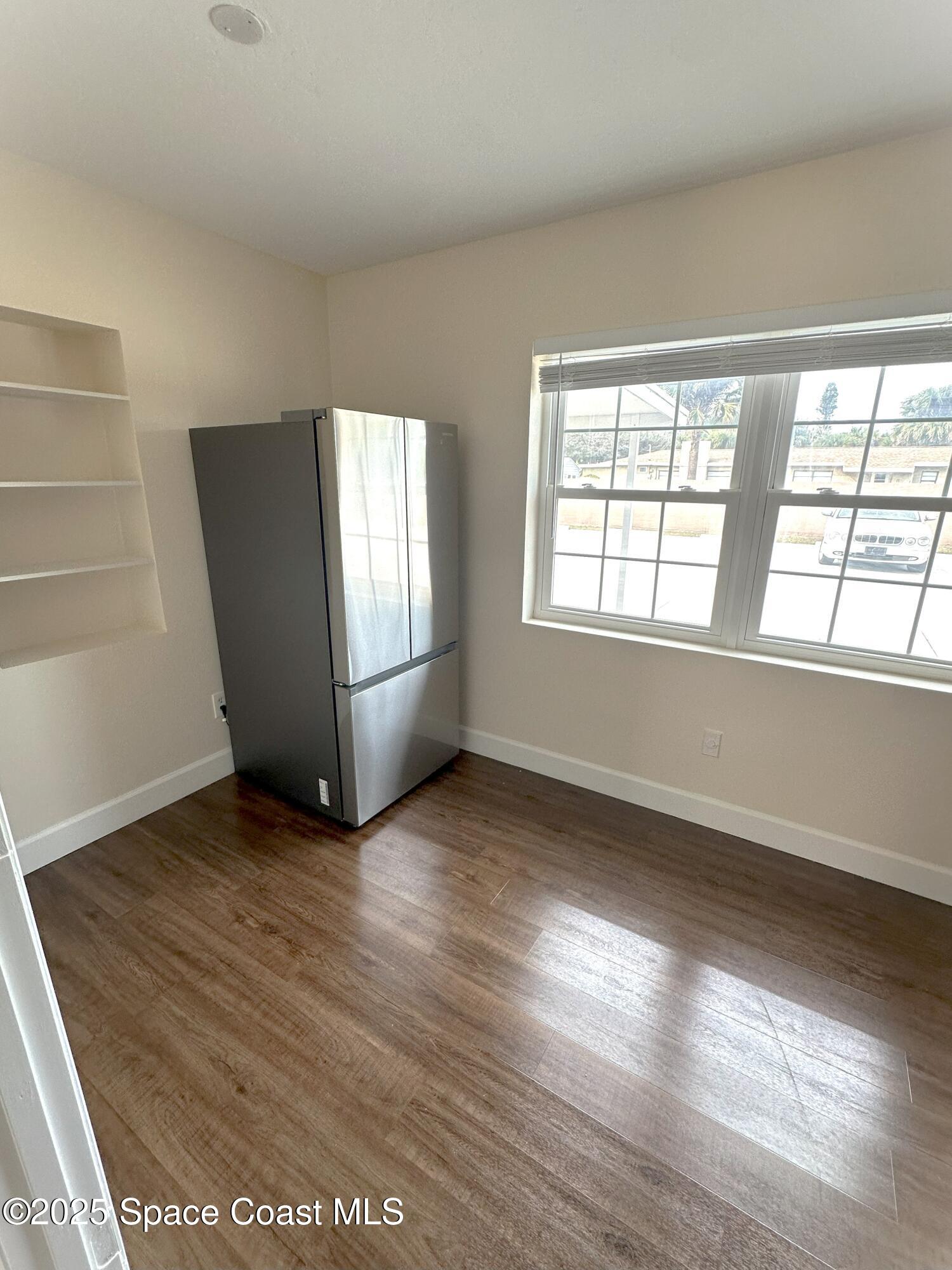 202 4th Avenue Indialantic, FL 32903 - Photo 6 of 6 an empty room with wooden floor and windows