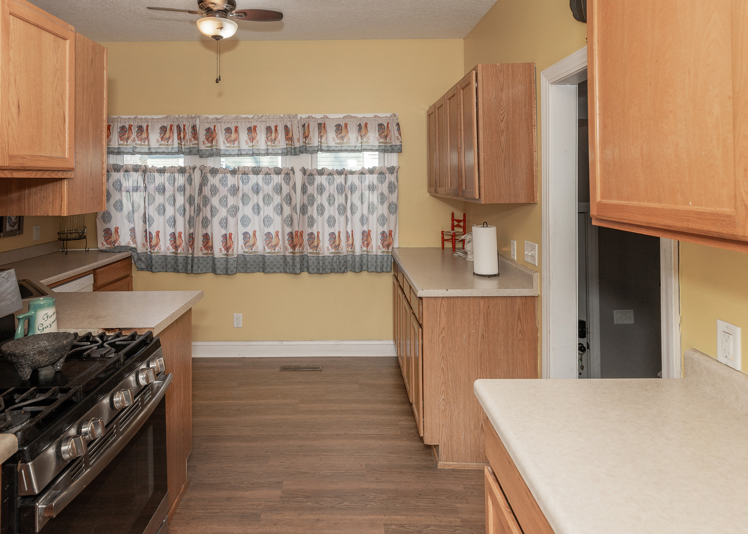 2330 38th Street Rock Island, IL 61201 - Photo 9 of 34 a kitchen with a stove and a wooden floor