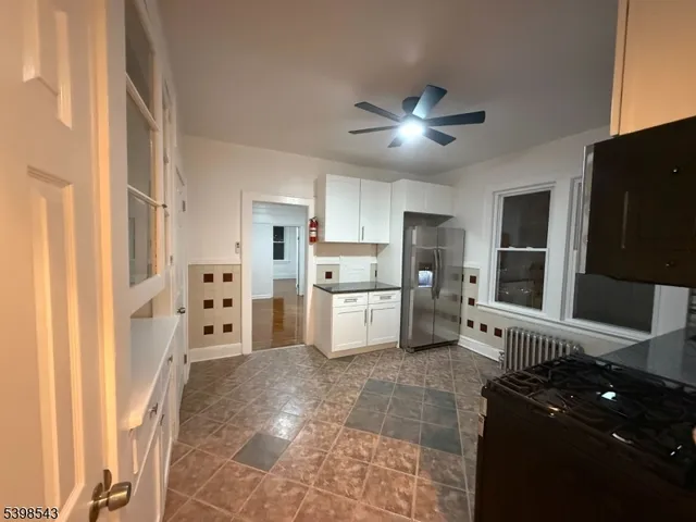 a kitchen with stainless steel appliances a refrigerator and a stove top oven