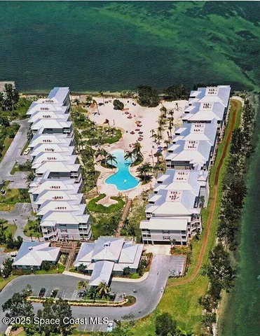 an aerial view of a residential houses with outdoor space